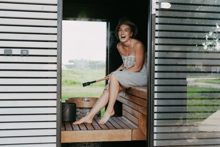 Quantum Healing & Techniques Woman laughing in a wooden sauna