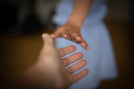 Quantum Healing & Techniques person holding babys hand