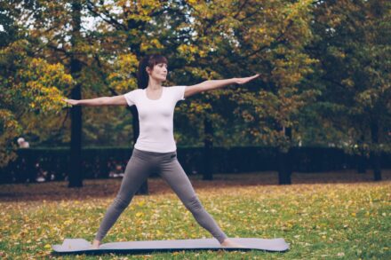 Quantum Healing & Techniques Woman practicing yoga in a park