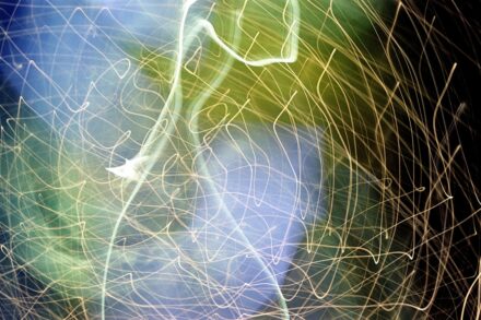 Quantum Physics for Healing integrating ayahuasca post-quantum Abstract streaks of light in blue, green, and yellow.