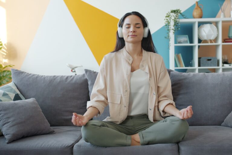 Quasar Quantum Healing Woman meditating on couch with headphones on