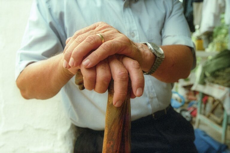 Reiki Healing a man holding a wooden stick in his hands