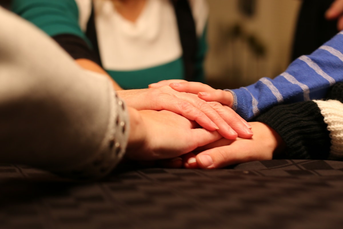 Reiki healing session with a practitioner's hands held over a client's open palm