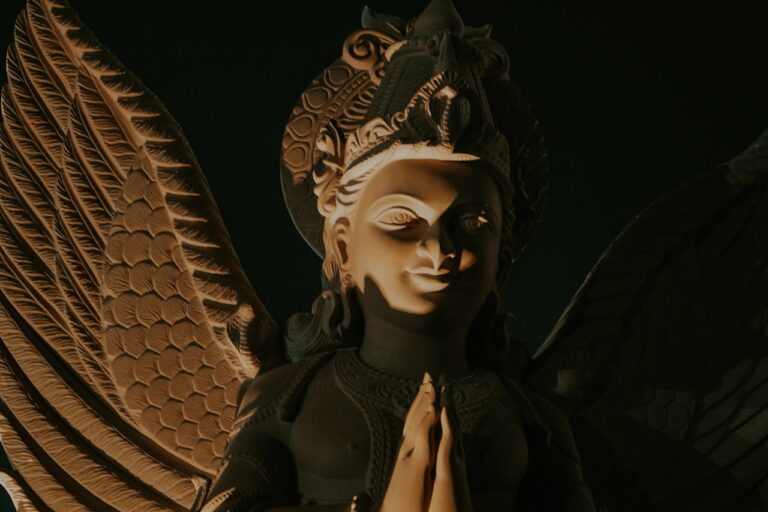 An angelic statue with wings and a headdress.