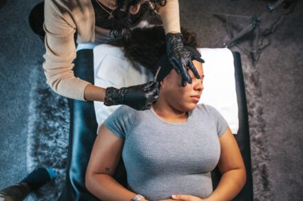 rTMS (Repetitive Transcranial Magnetic Stimulation) a woman getting her hair cut by a hair stylist