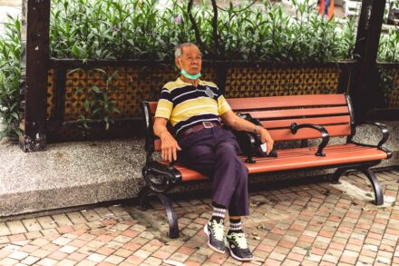 Salt Therapy woman in blue and yellow stripe shirt sitting on brown bench