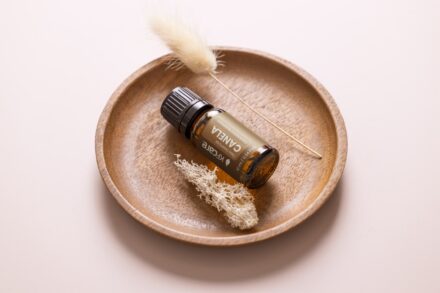 a small bottle of essential oils sitting on a plate