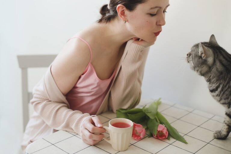 Aromatherapy a person sitting on a chair with a cat and a cup of tea