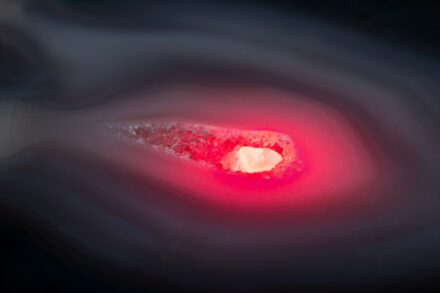 A close up of a red object with a black background