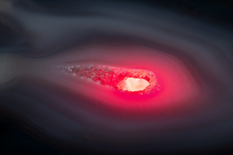 A close up of a red object with a black background
