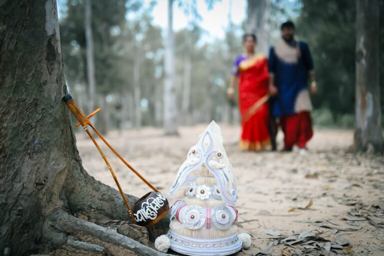 Two people walking in the woods with a small tree