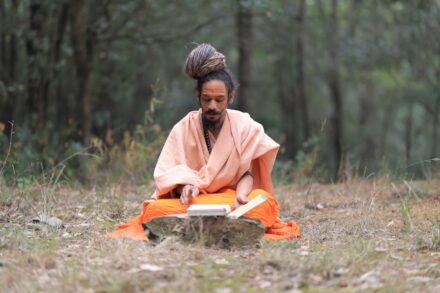 A person sitting in the middle of a forest