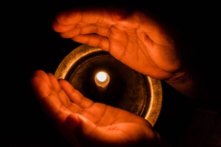 shamanic spirit guide journey healing quasar a person holding a lit candle in their hands