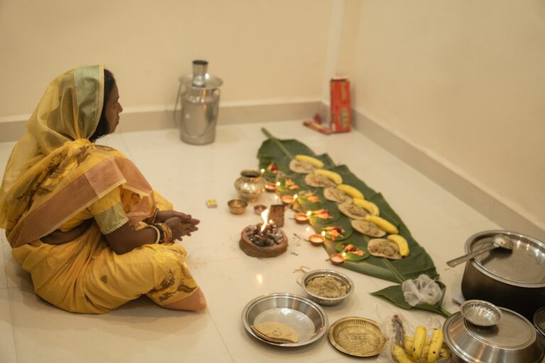 Spiritual and Cultural Healing Woman in yellow sari participates in a ritual with offerings.