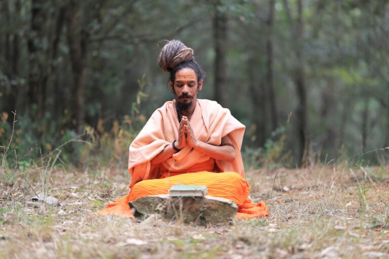 Spiritual Healing A man sitting on a rock in the middle of a forest
