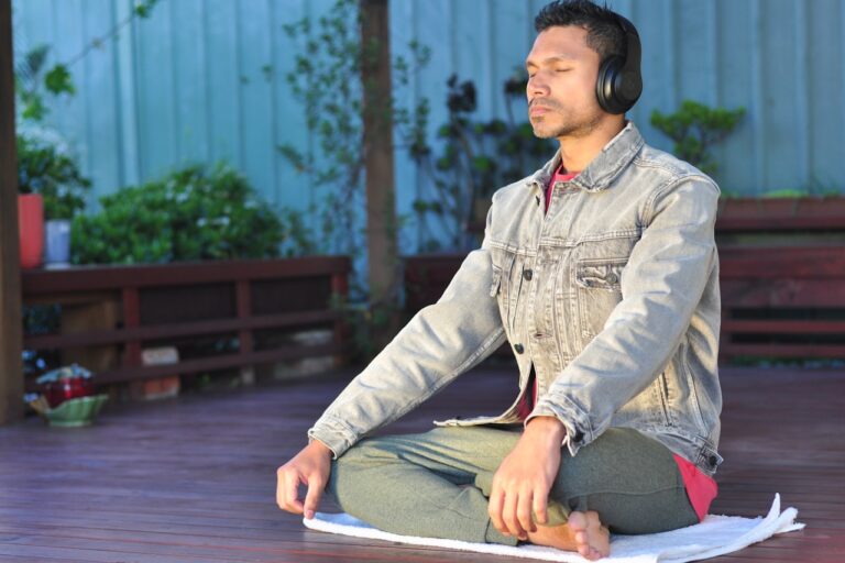 Spiritual Healing a man sitting on a table wearing headphones