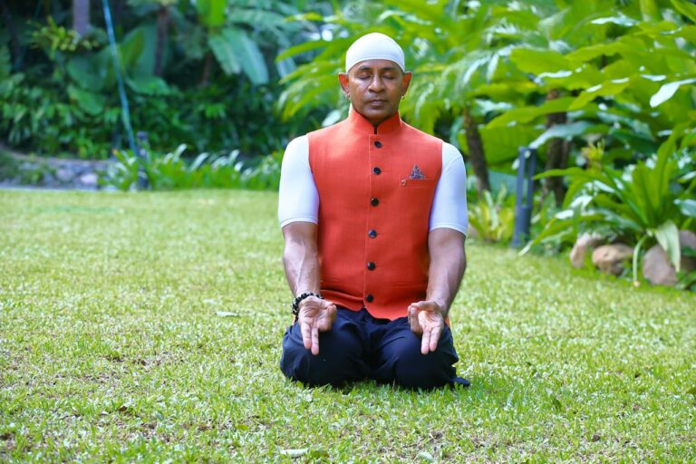 Spiritual Healing A man in a red vest sitting in a yoga position