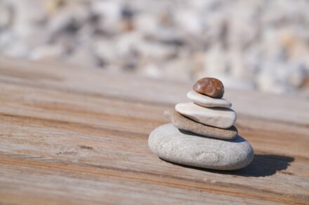 Stack of smooth stones on a wooden surface
