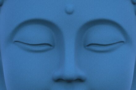 Close up of a serene blue buddha statue