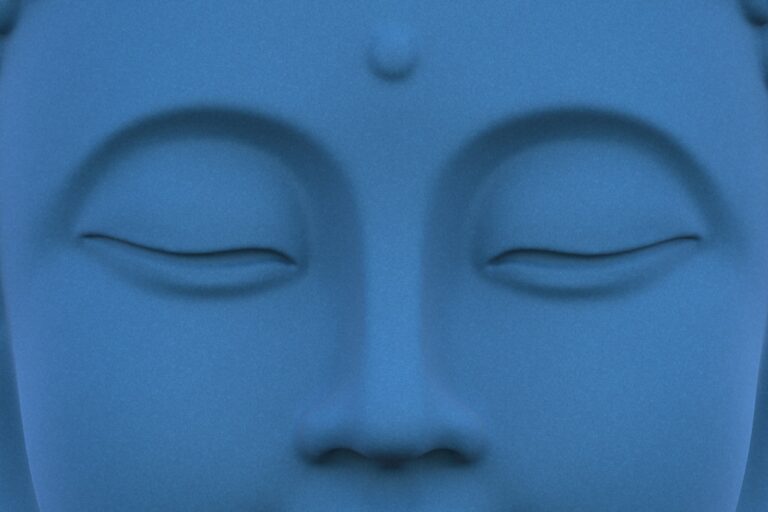 Close up of a serene blue buddha statue