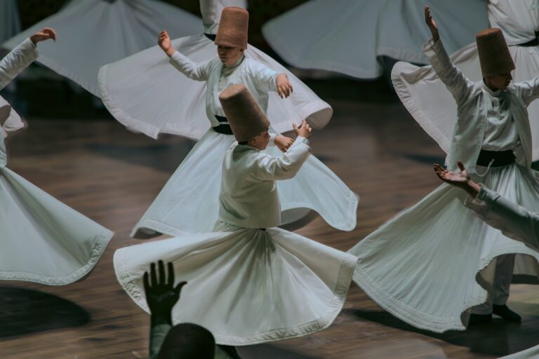 Whirling dervishes perform a spiritual dance in white robes.