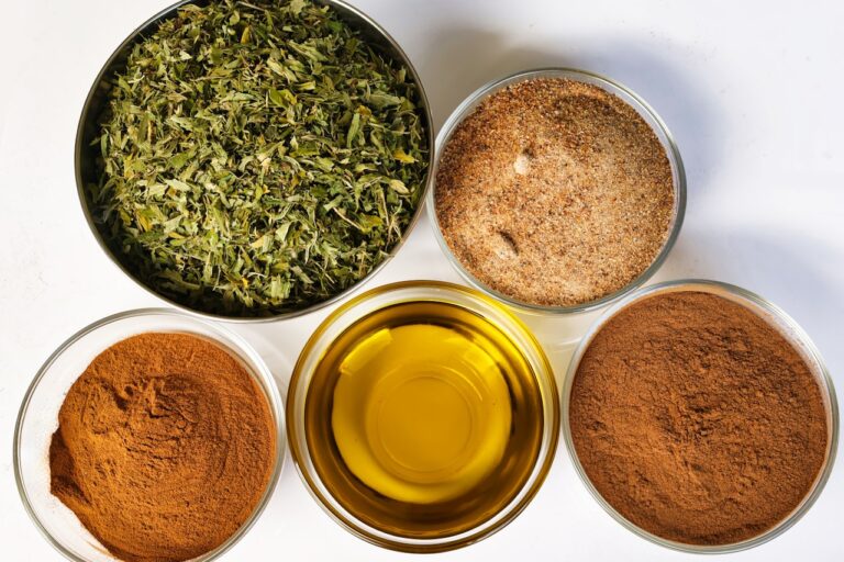 Four bowls filled with different types of spices