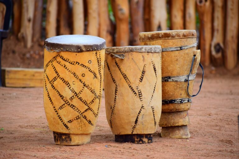brown wooden barrels on brown sand