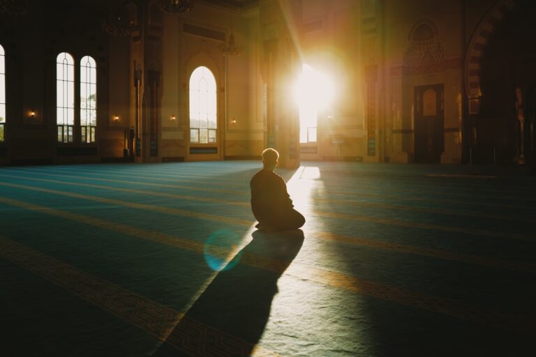 Person sitting in a large, sunlit hall