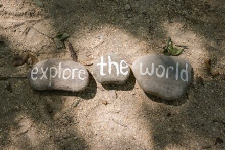 two rocks with the words explore the world written on them
