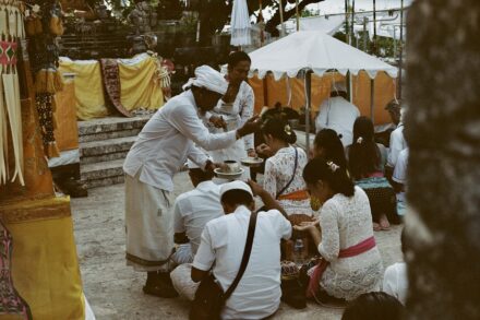 Traditional and Cultural Practices people sitting on ground beside trees during daytime