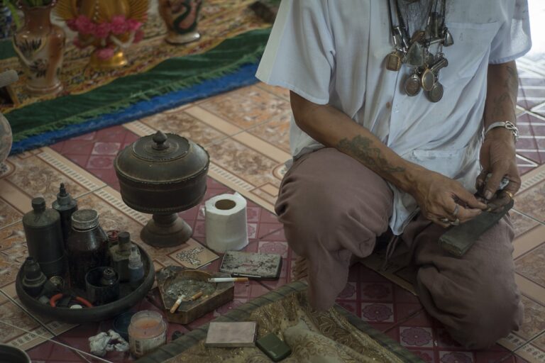 Traditional Healing Practices man in white button up t-shirt and brown pants sitting on floor
