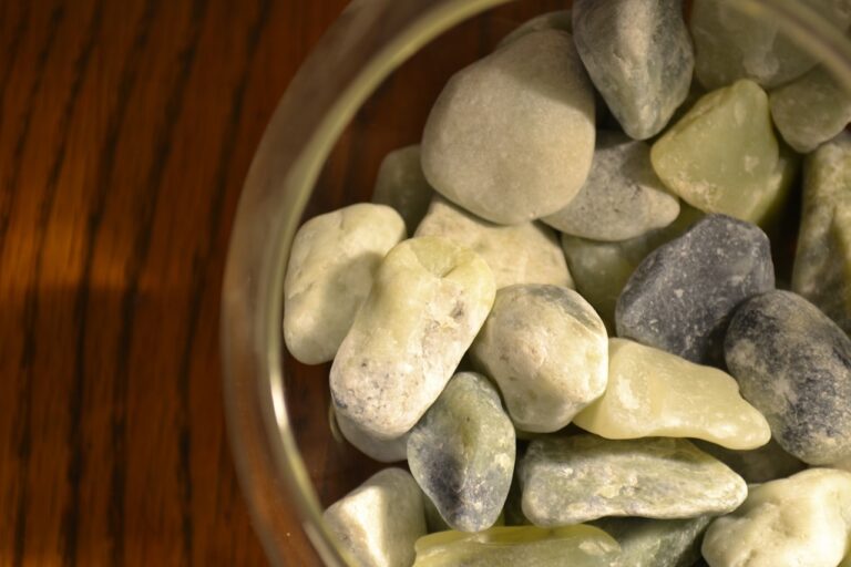 A glass bowl filled with rocks on top of a wooden table