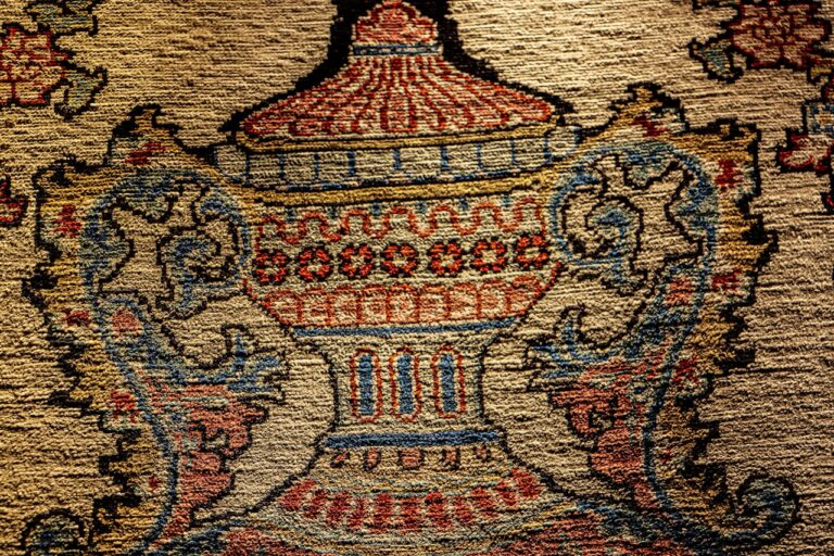 A close up of a rug with a vase on it