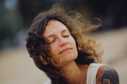 Person practicing vagus nerve stimulation natural breathing technique outdoors
