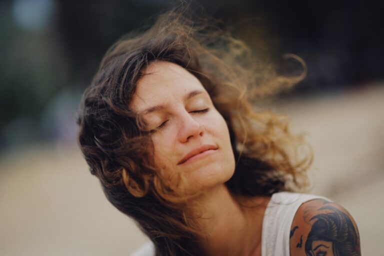 Person practicing vagus nerve stimulation natural breathing technique outdoors