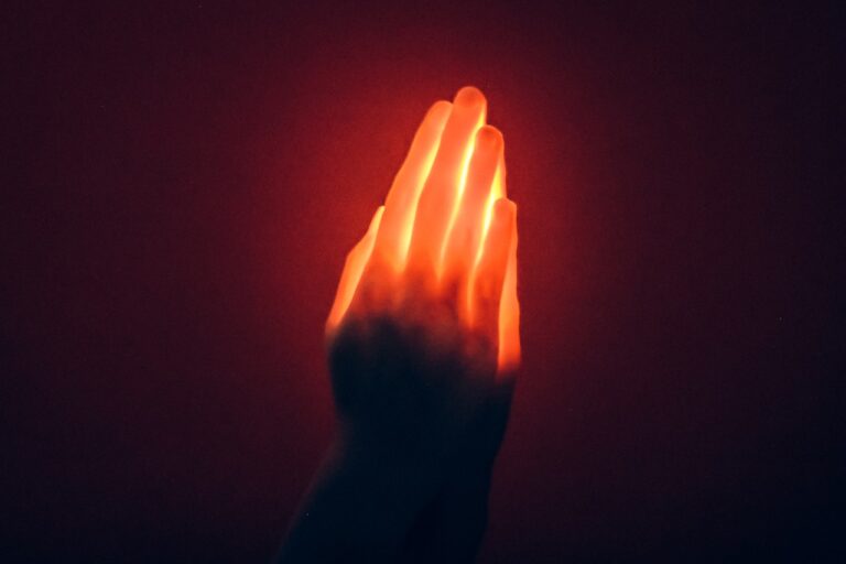 Energy Healing A hand holding a glowing object in the dark
