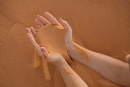 Energy Healing persons feet on brown sand