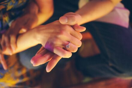 Energy Healing Couple holding hands with engagement ring