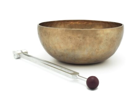 Energy Healing stainless steel spoon beside brown ceramic bowl