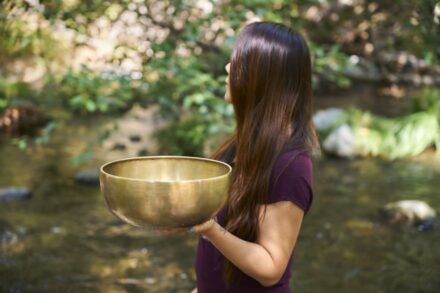 Energy Healing A woman holding a large bowl in her hands