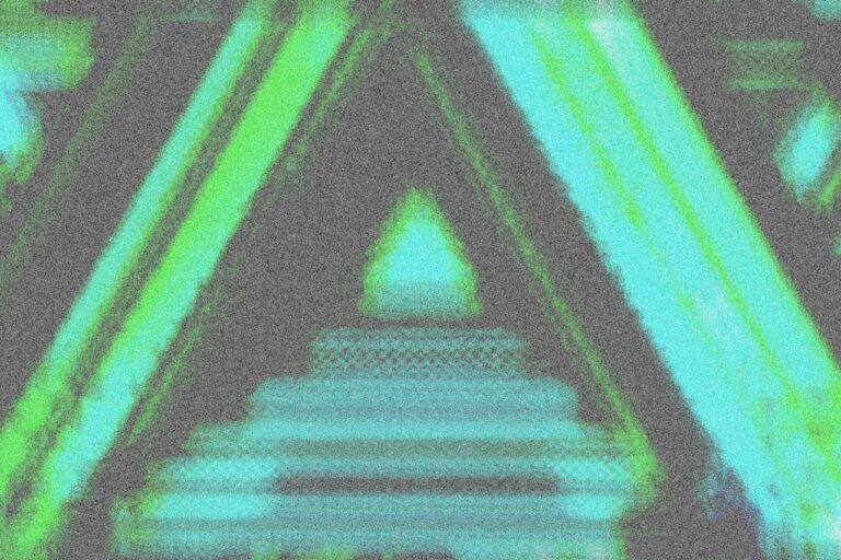 A blurry image of a building with a green triangle