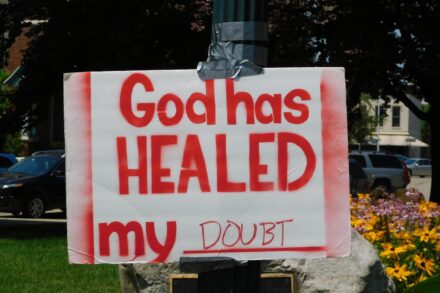 What Chakra Needs Healing? 3 God has healed my doubt placard posted on pole
