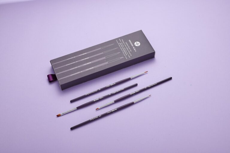 a set of five pencils and a box of pencils on a purple surface