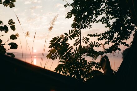 Yoga The sun is setting over a body of water